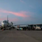 TOPSHOT - Migrants board a plane during the first deportation flight of undocumented Venezuelans from the United States to Venezuela, in Harlingen, Texas, on October 18, 2023. The United States said on October 5, 2023 it will resume deportation flights to Venezuela after a deal with Caracas, as President Joe Biden, seeking reelection, comes under pressure to halt border crossings. Washington has for years halted sending migrants back to Venezuela due to instability in the South American nation and still maintains sanctions against the government of President Nicolas Maduro. (Photo by VERONICA G. CARDENAS / AFP) (Photo by VERONICA G. CARDENAS/AFP via Getty Images)