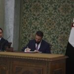 Syrian leader signs constitution that puts the country under an Islamist group's rule for 5 years