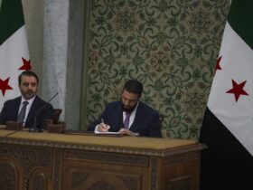 Syrian leader signs constitution that puts the country under an Islamist group's rule for 5 years