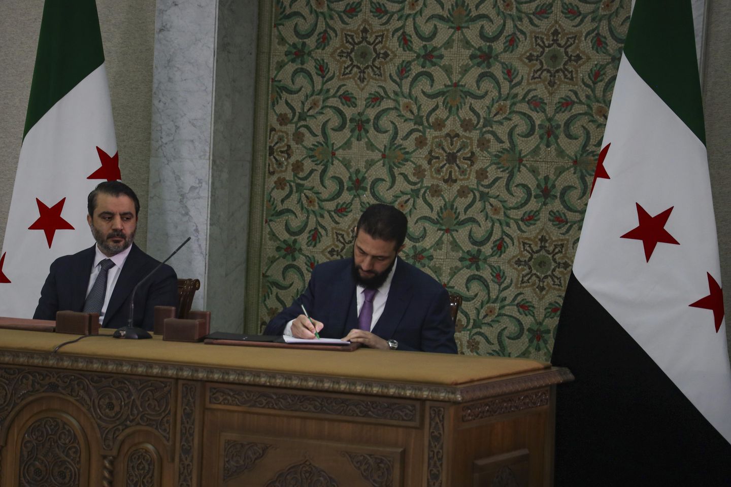 Syrian leader signs constitution that puts the country under an Islamist group's rule for 5 years