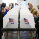 HENDERSONVILLE, NORTH CAROLINA - OCTOBER 17: Voters make selections at their voting booths inside an early voting site on October 17, 2024 in Hendersonville, North Carolina. Several counties effected by Hurricane Helene saw a large turnout of residents for the first day of early voting in Western North Carolina. (Photo by Melissa Sue Gerrits/Getty Images)