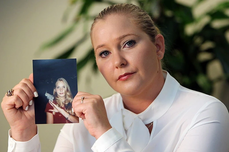 Virginia Roberts Giuffre holds a photo of herself as a teen, when she says she was abused by Jeffrey Epstein, Ghislaine Maxwell and Prince Andrew, among others. (Emily Michot/Miami Herald/Tribune News Service via Getty Images)