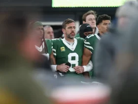 New York Jets quarterback Aaron Rodgers (8) stands with teammates during the national anthem before the game against the Miami Dolphins at MetLife Stadium. Vincent Carchietta-Imagn Images/ File Photo