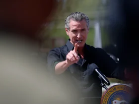 CERES, CALIFORNIA - APRIL 16: California Governor Gavin Newsom speaks during a news conference at Gemperle Orchard on April 16, 2025 in Ceres, California. Governor Gavin Newsom and California Attorney General Rob Bonta have filed a lawsuit in federal court challenging the Trump administration