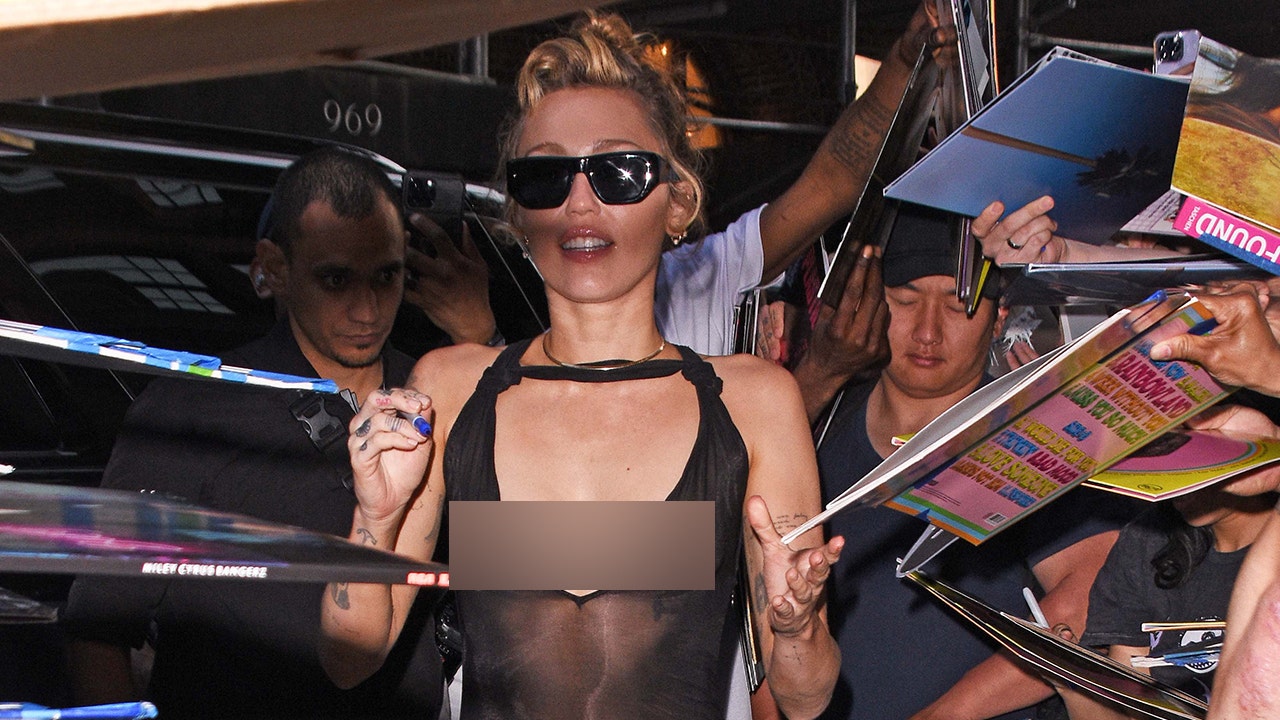 Miley Cyrus goes braless in sheer black dress during album promotion
